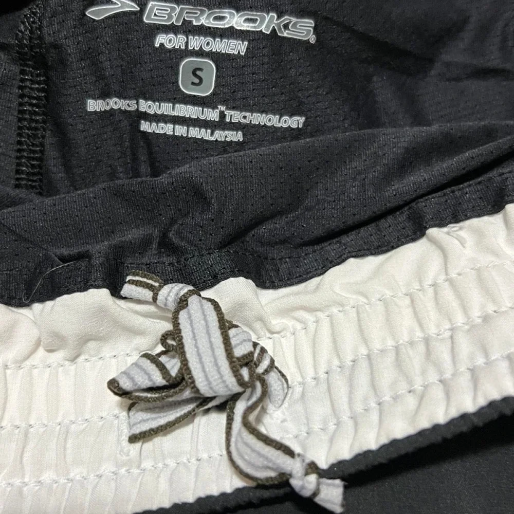Brooks black running shorts with white side stripes 314.5